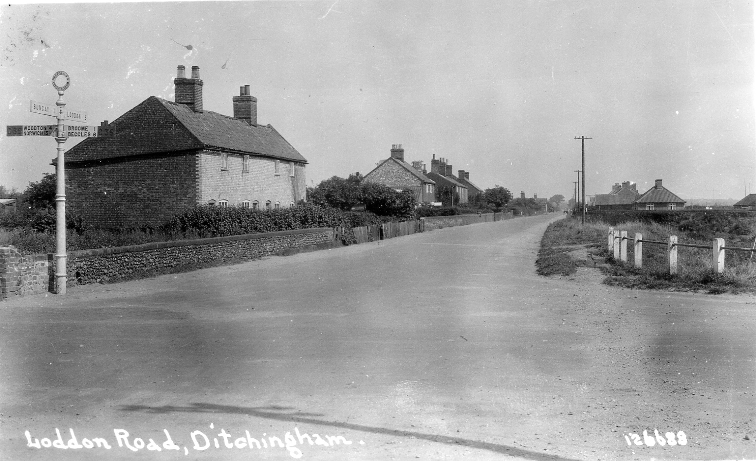 Ditchingham crossroads looking towards Loddon - the village shop is now on the left past these cottages.